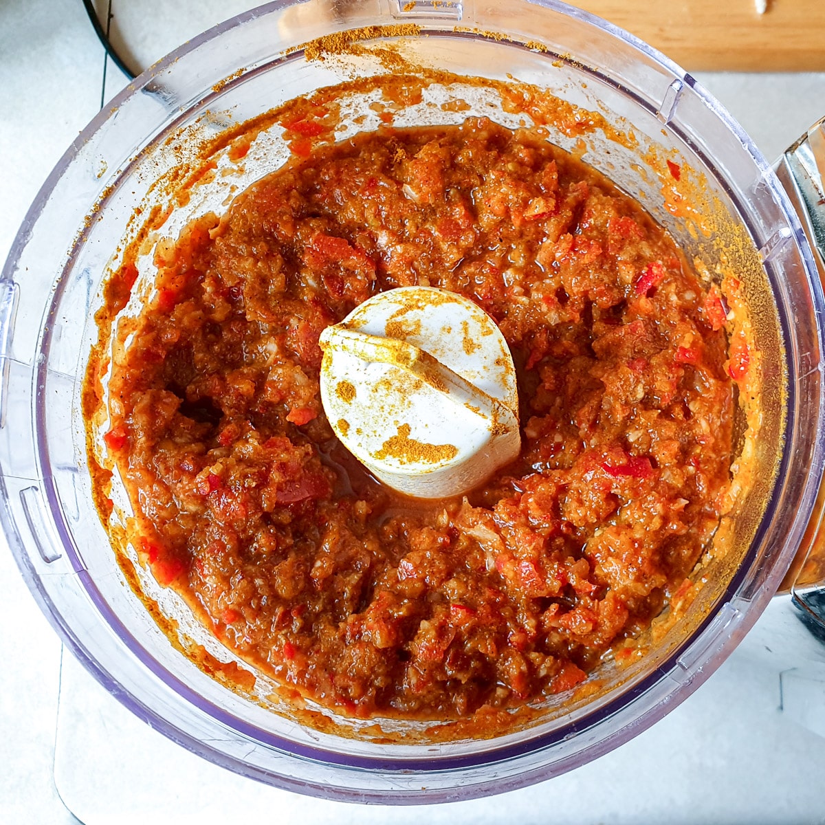 Red peppers and onions blended to a paste with spices in a food processor.