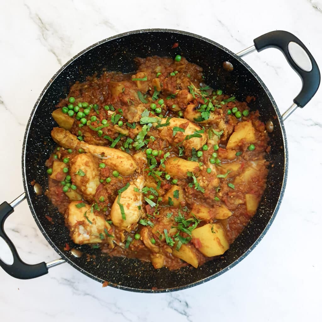 The finished dish of chicken bhuna garnished with coriander.