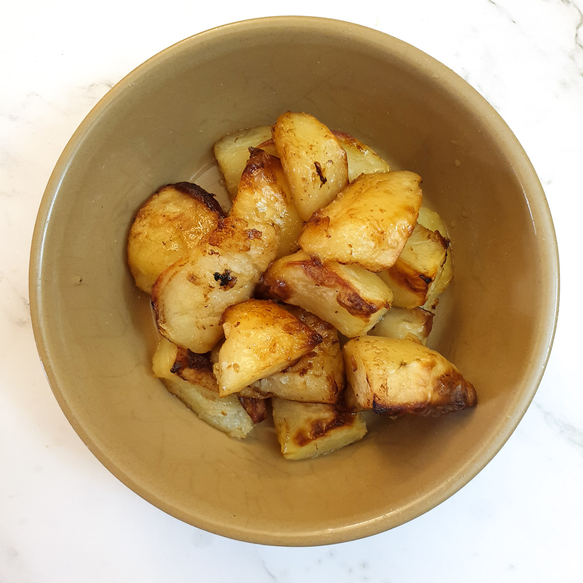 Duck fat roasted potatoes in a dish.