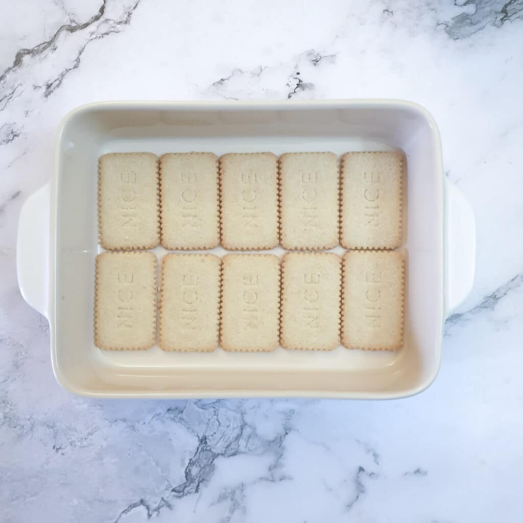 10 biscuits arranged in a single layer in a baking dish.