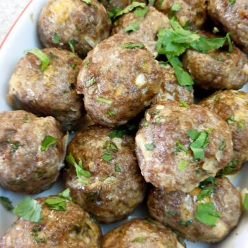 Closeup of a dish of Moroccan lamb meatballs.