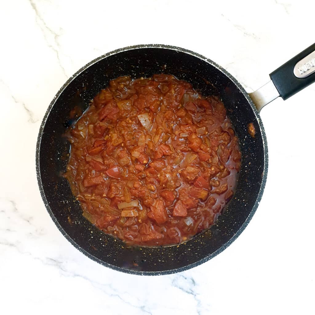 A frying pan filled with homemade tomato sauce.