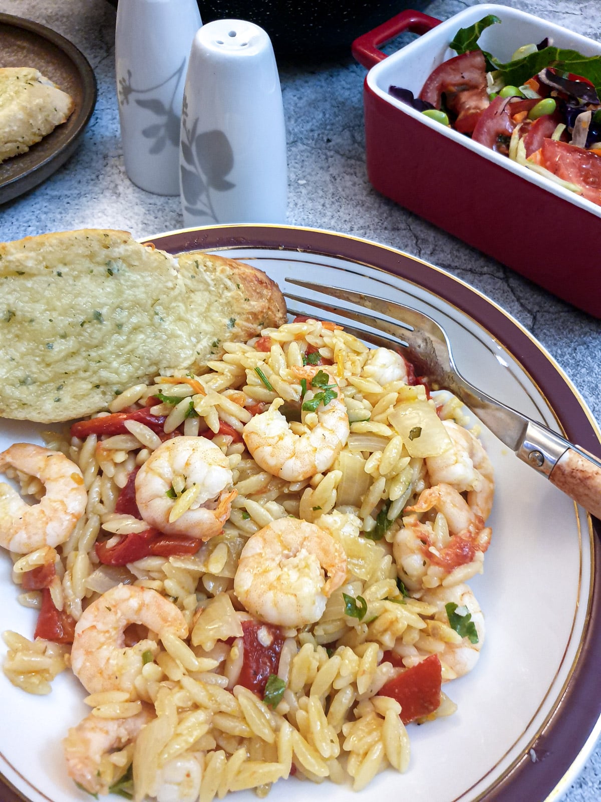 A plate of red pepper pasta with prawns.