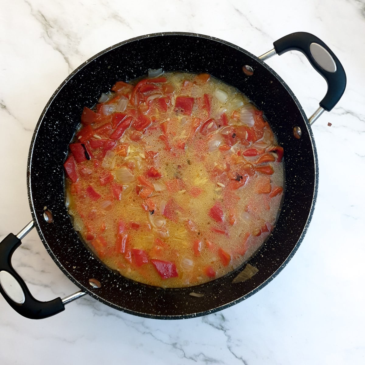  Pasta and stock added to the frying pan.