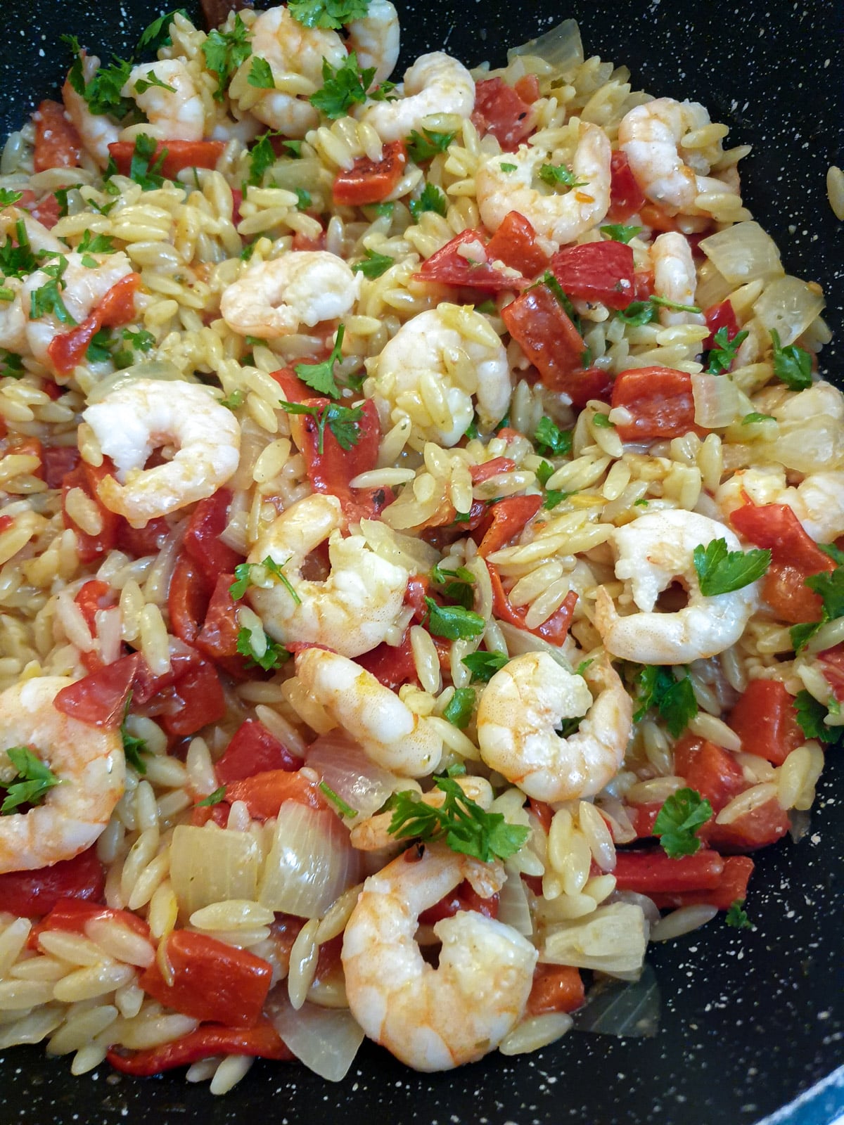 Closeup of roasted red pepper pasta with prawns.