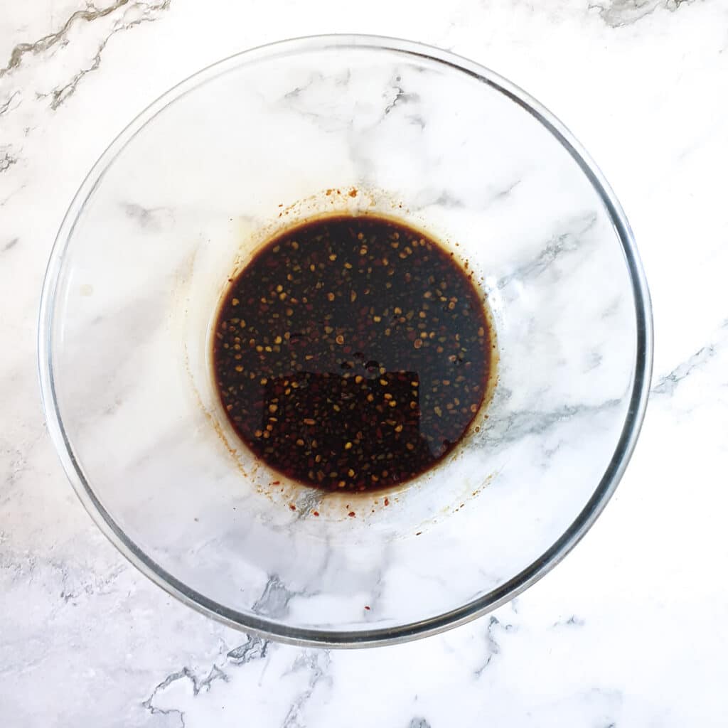 Honey and soy marinade ingrdients in a glass mixing bowl.