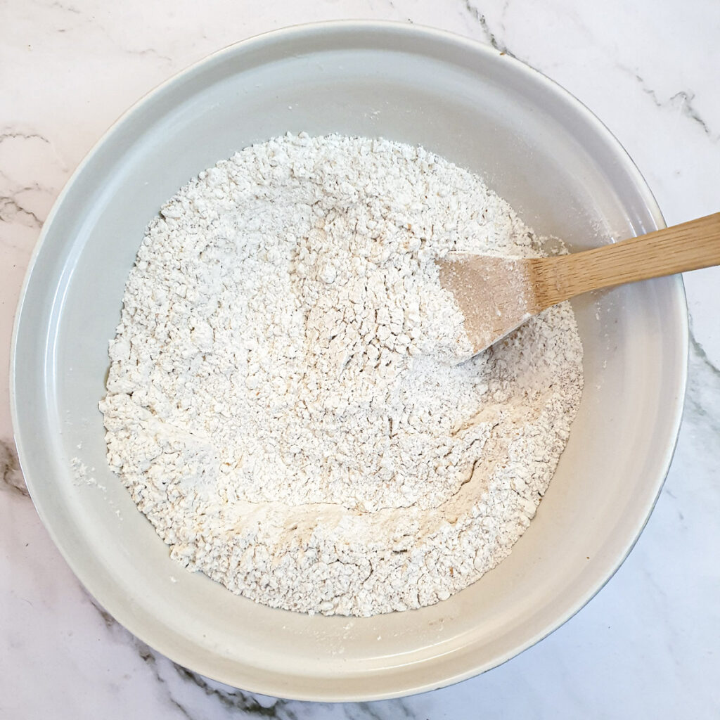 Flour and oats combined in a mixing bowl.