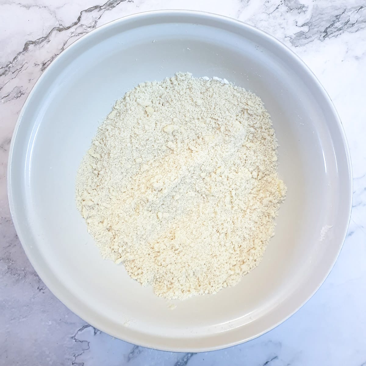 Flour and butter rubbed to fine breadcrumbs in a mixing bowl.