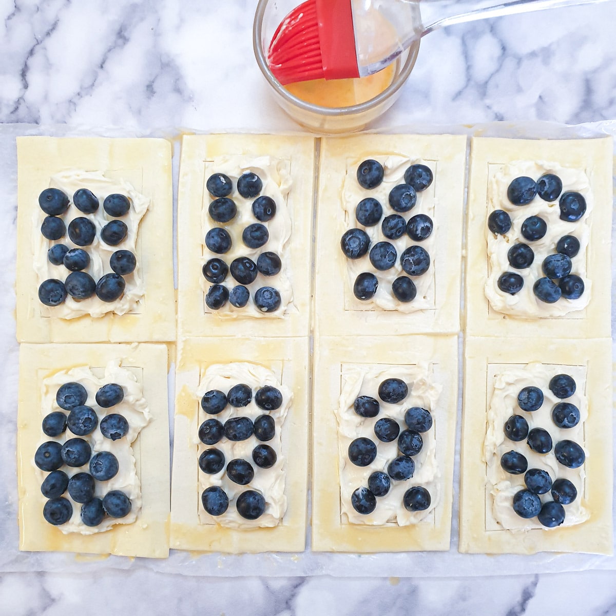 8 rectangles of puff pastry spread with mascarpone cheese and covered with blueberries.