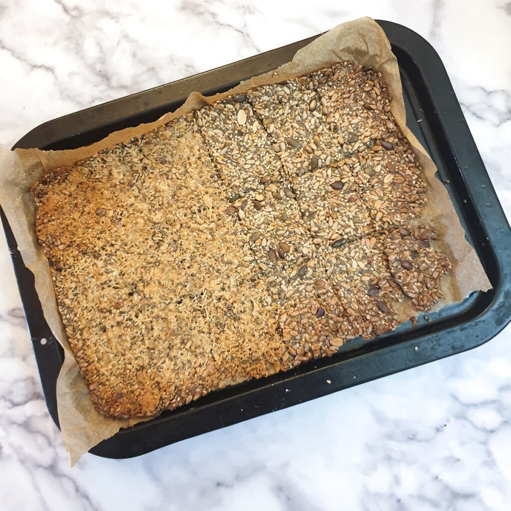 A baked tray of seeded crackers.