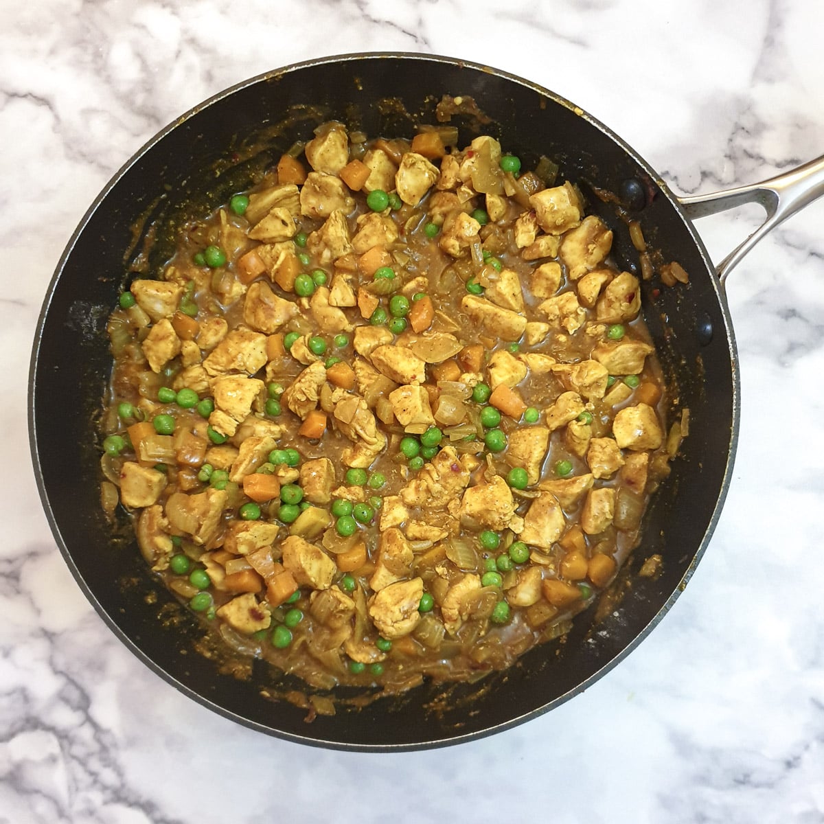 Frozen peas mixed into the curry mixture.