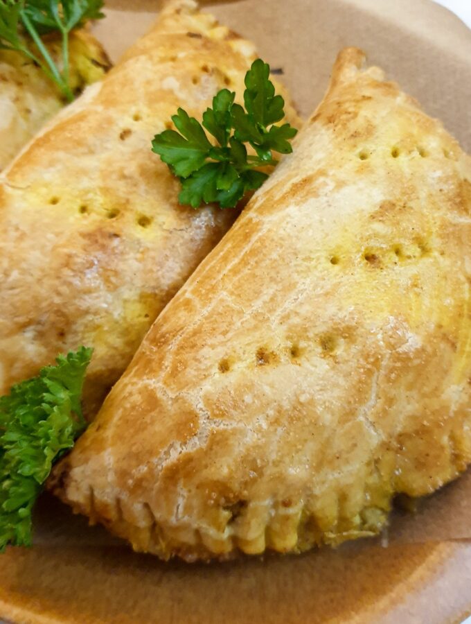 Closeup of a curried chicken pie on a plate.