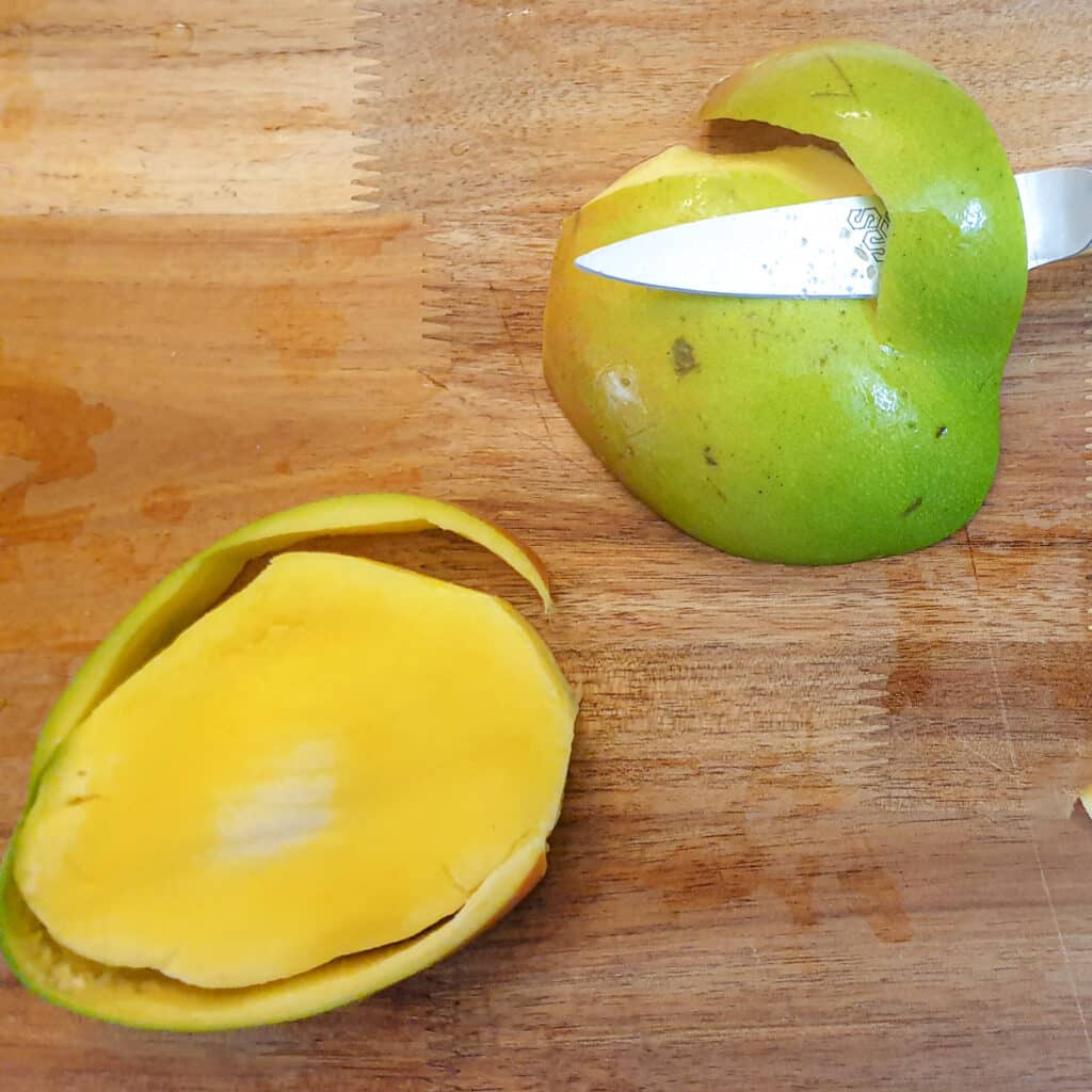 A mango pip cut from the centre of a mango, with the skin removed.