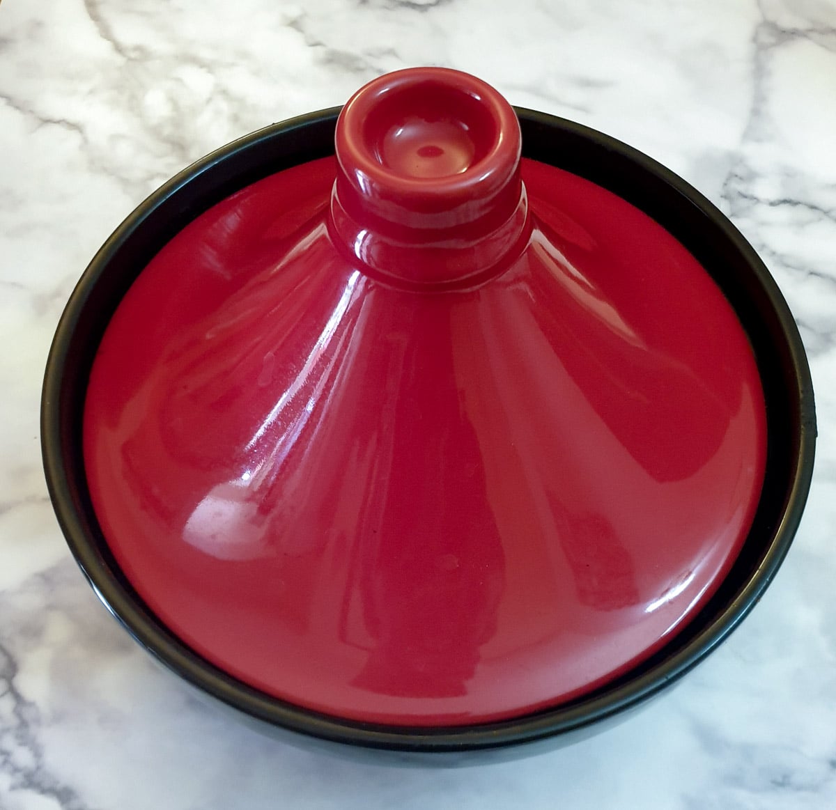 Overhead shot of a tagine with a red-domed lid.