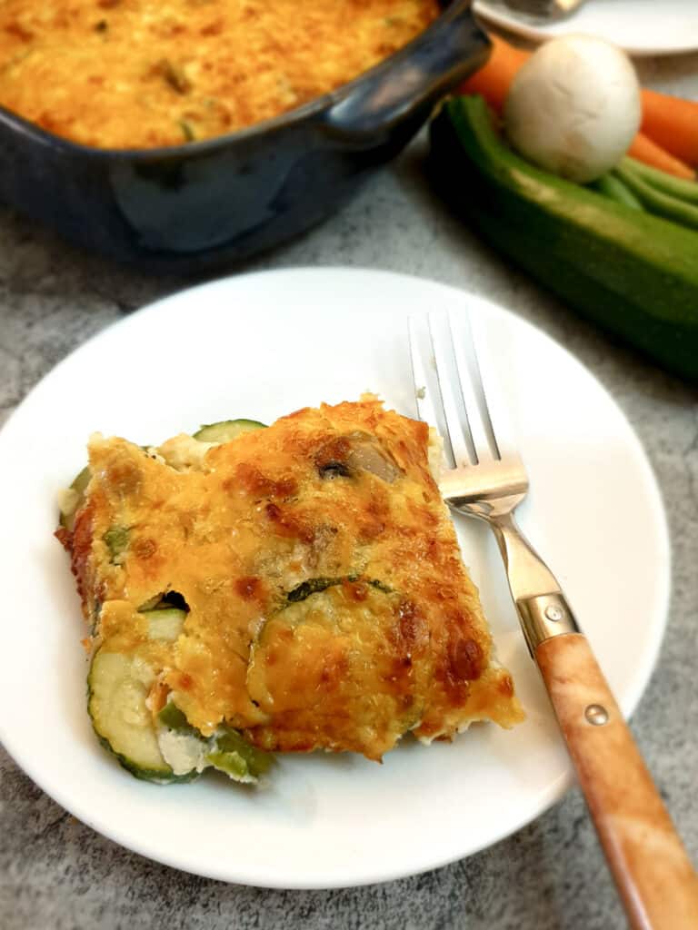 A slice of crustless vegetable quiche on a plate.