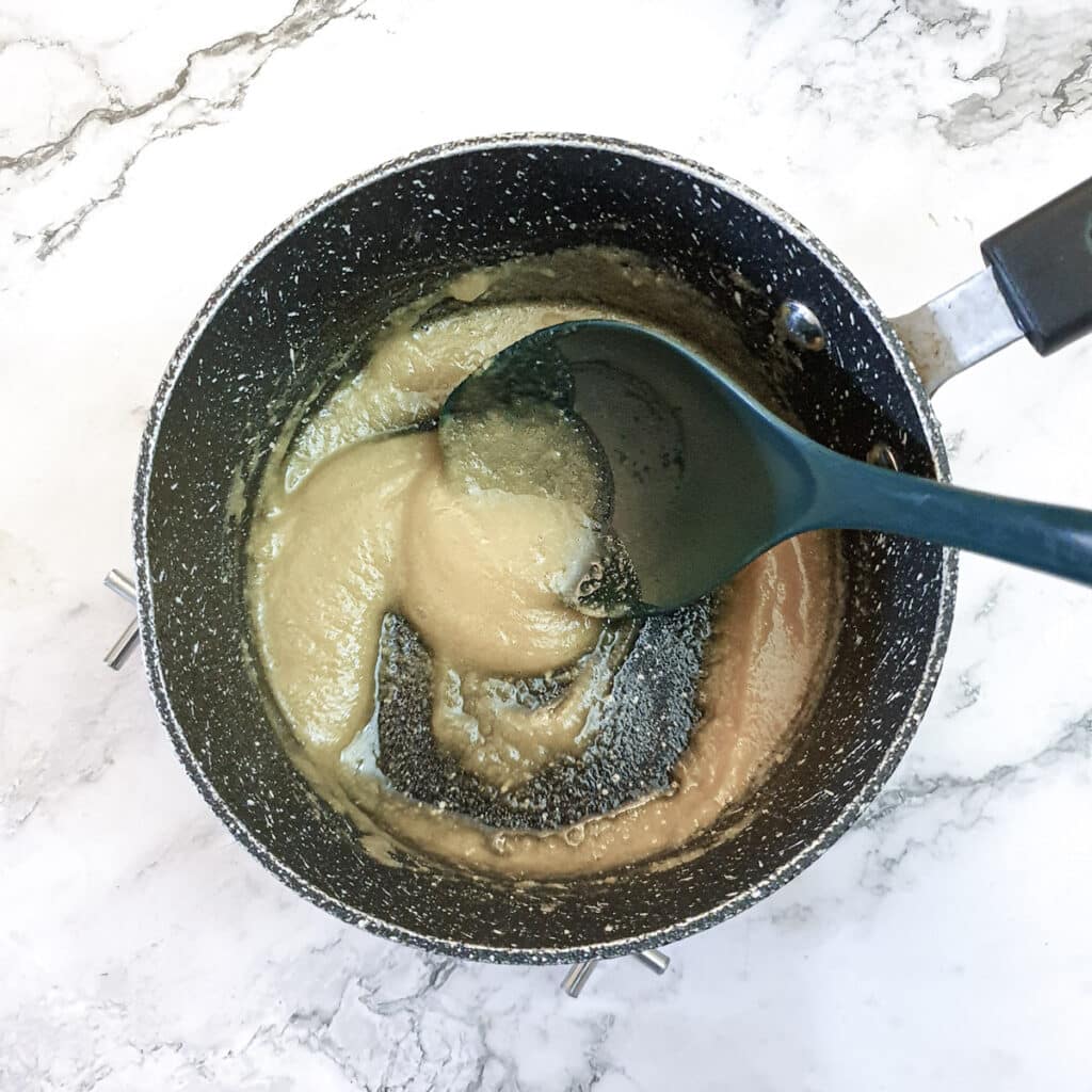 Flour mixed with butter in a saucepan to form a roux.