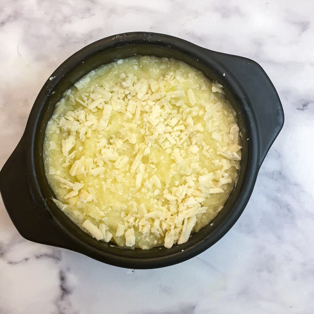 Cheesy gem squash in a baking dish ready to go into the oven.