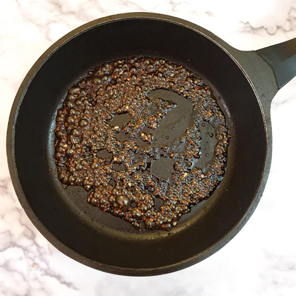 Garlic sauce bubbling in a frying pan.