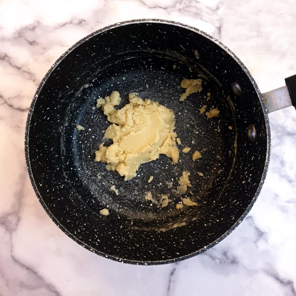 Butter and flour combined in a saucepan.