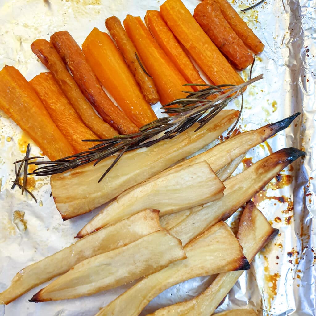 Overhead shot of cooked honey-roasted carrots and parsnips.