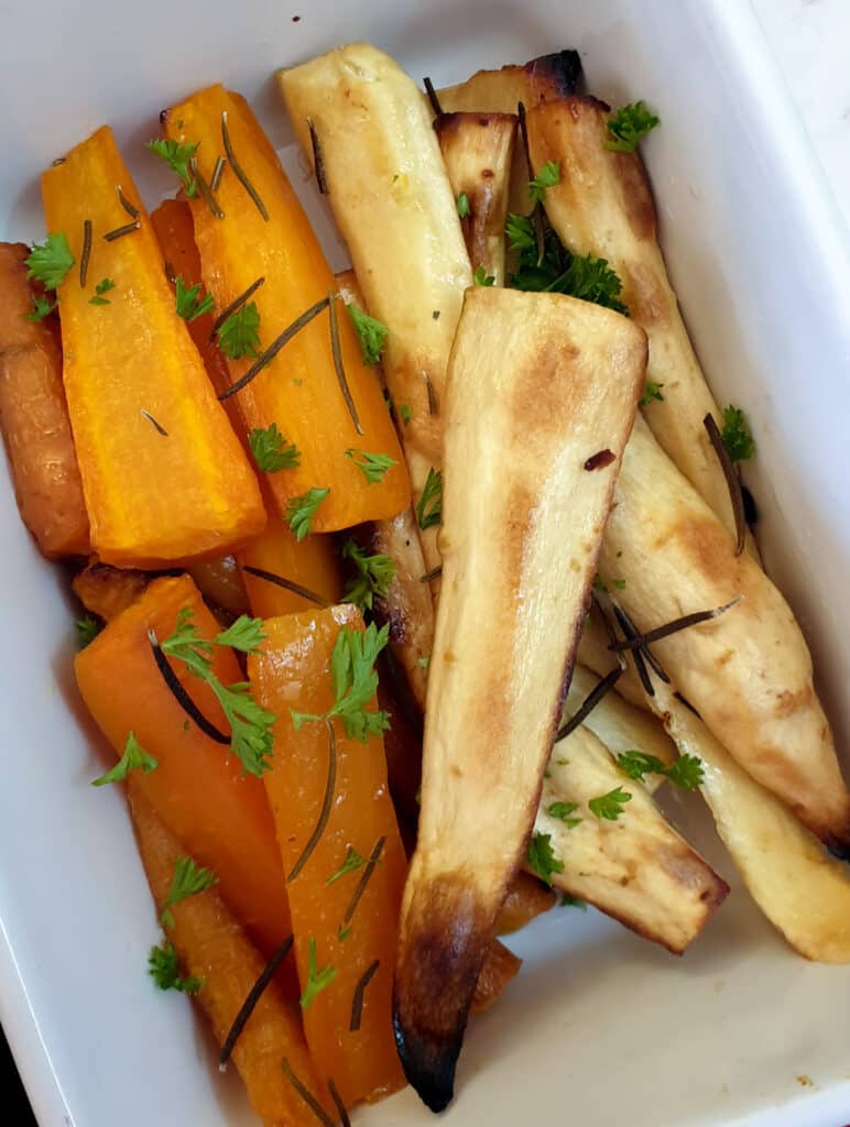 Honey-roasted carrots and parsnips in a serving dish.