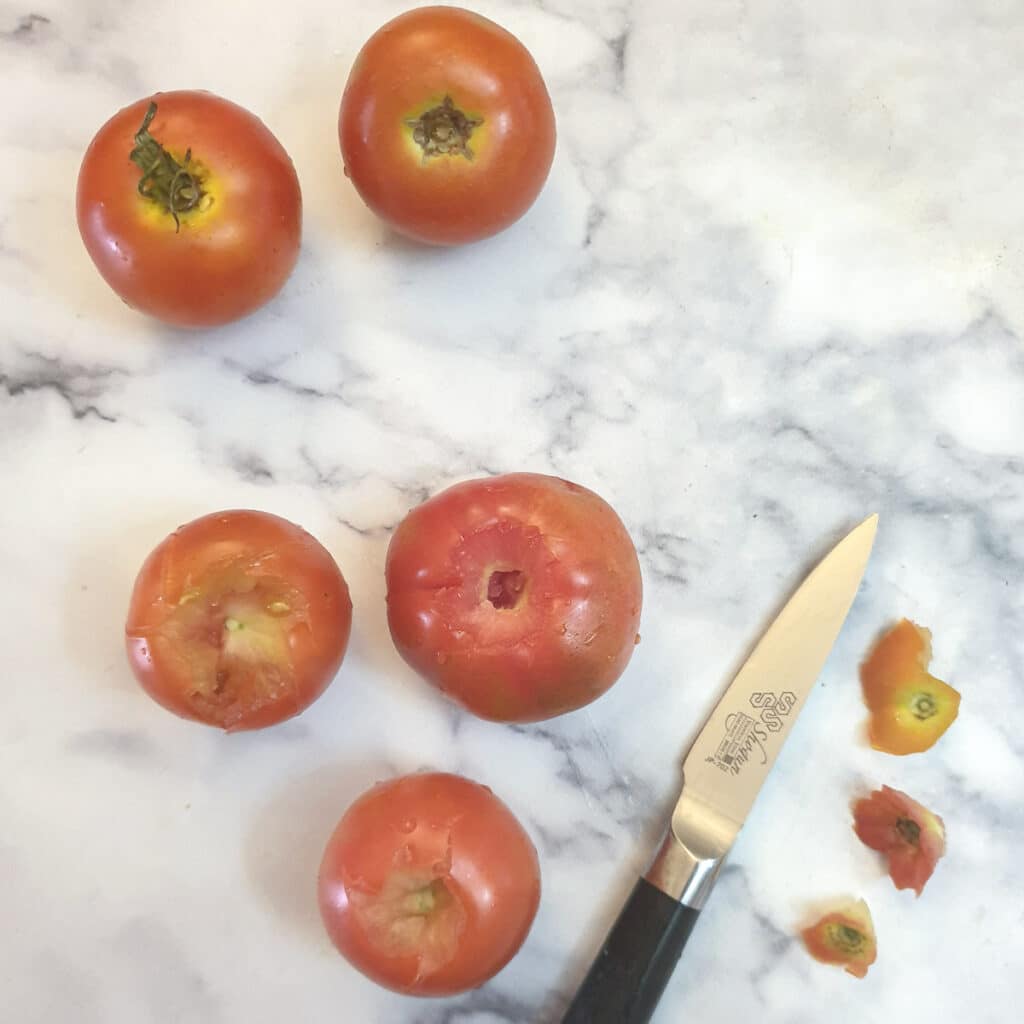 5 tomatoes with the core removed.