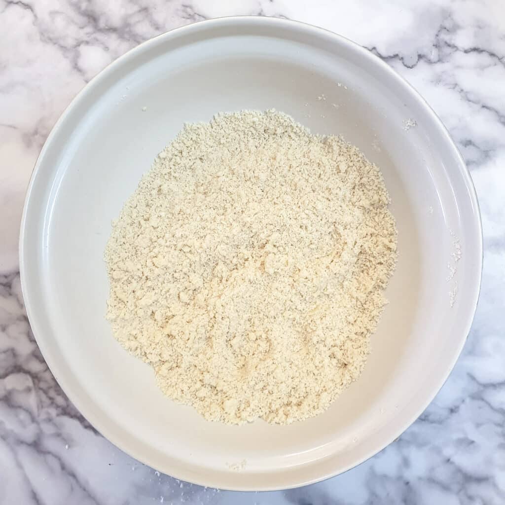 Butter and flour rubbed together to form breadcrumbs in a large mixing bowl.