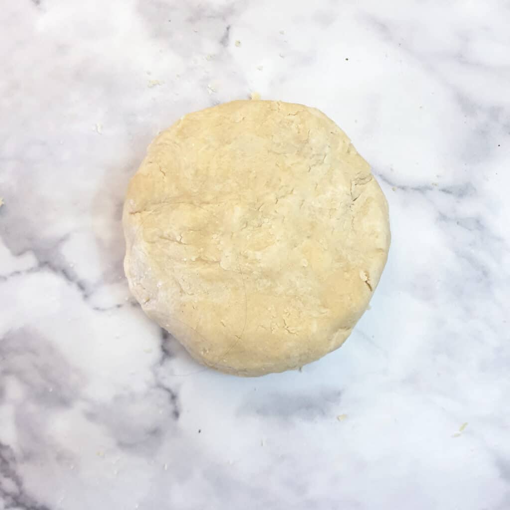 A ball of dough on a marble surface.