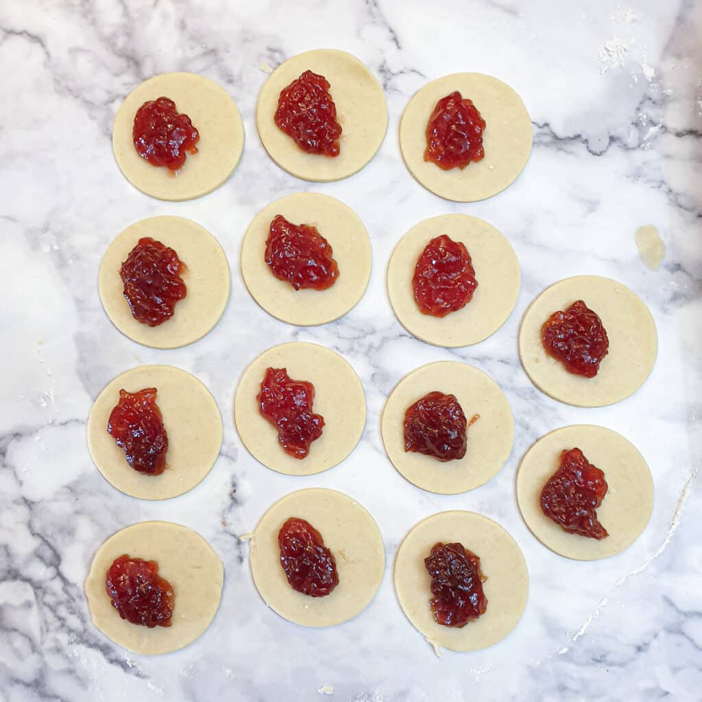 14 circles of pastry with half a spoonful of jam on each.