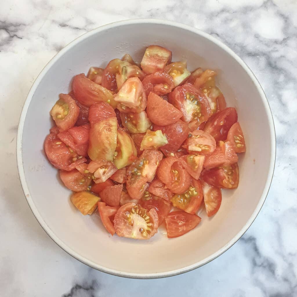 A while bowl of chopped tomatoes.
