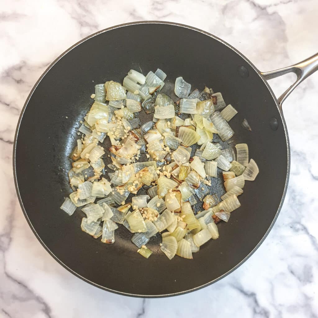 Onions and garlic in a frying pan.