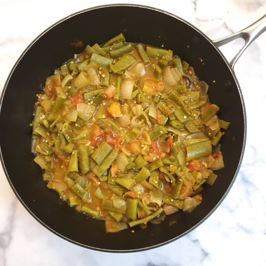 Middle Eastern-style runner beans in a frying pan.