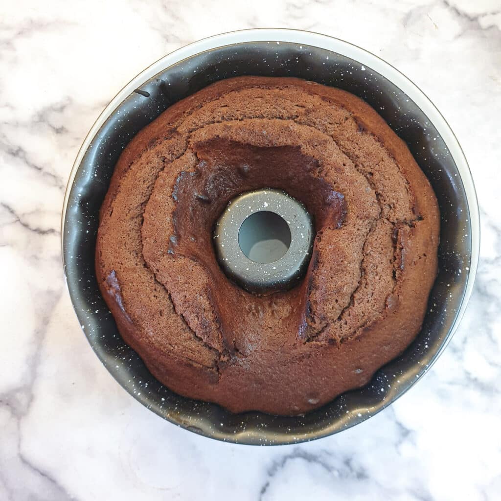 A baked chocolate cake in a round bundt pan.