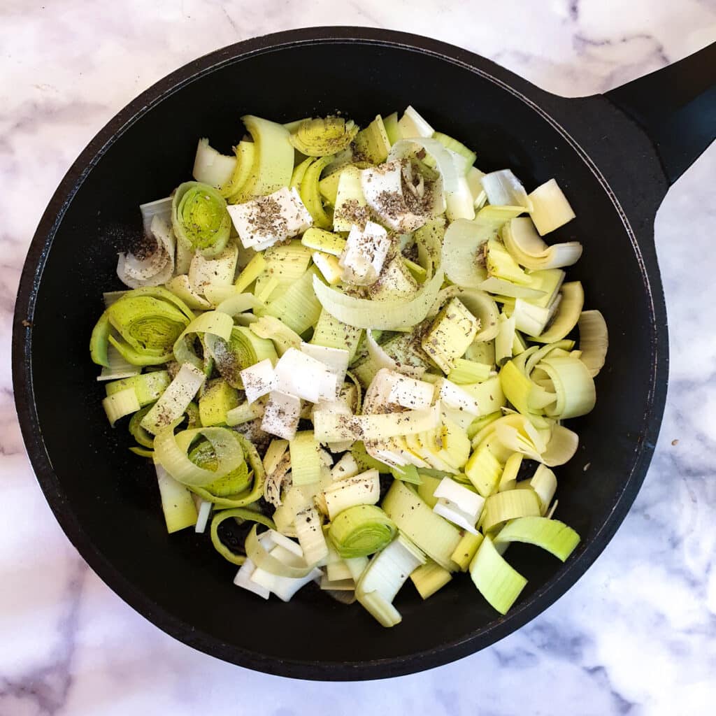 Chopped leeks in a frying pan.