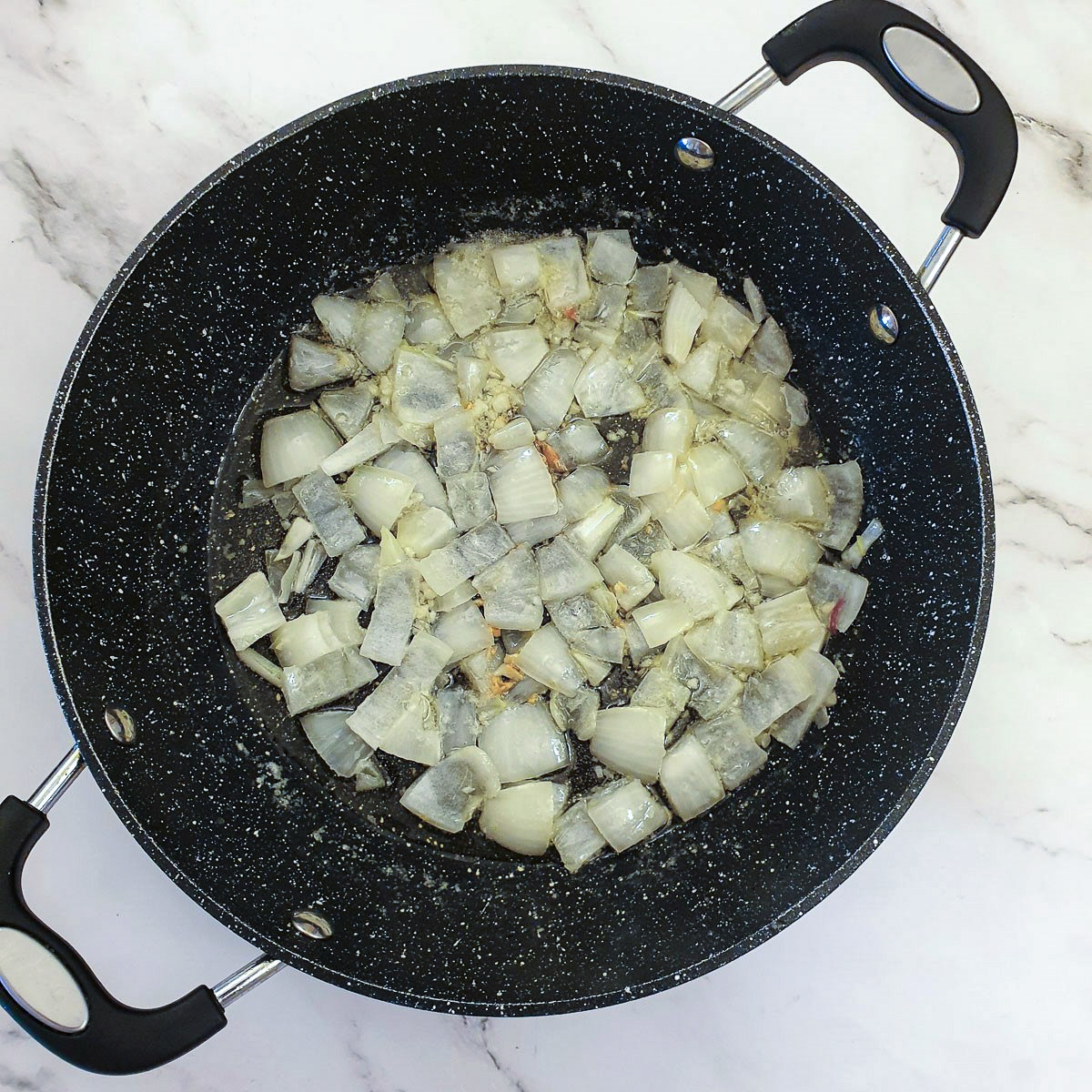 Chopped onions in a frying pan.