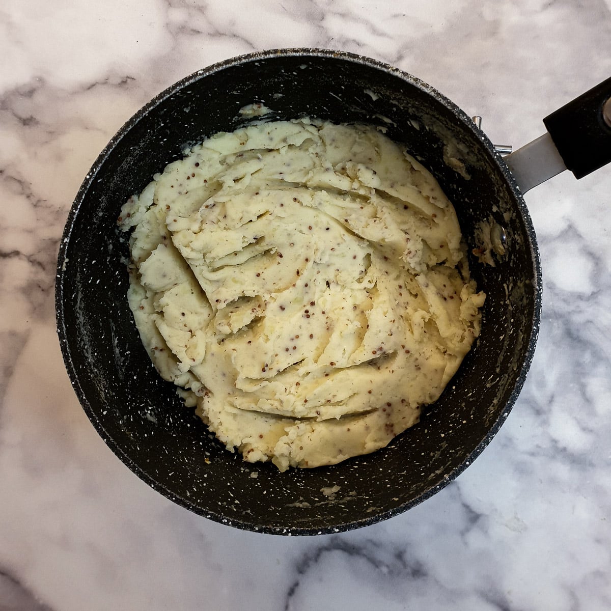 A saucepan of mustard mashed potatoes.