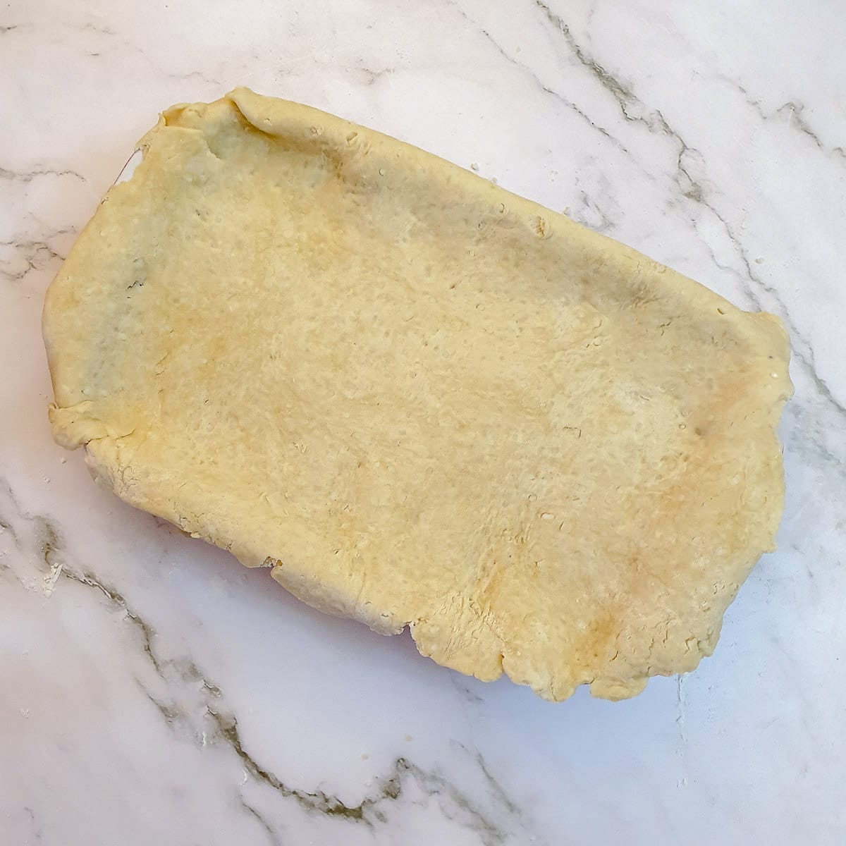 Suet pastry laid over a meat and potato pie.