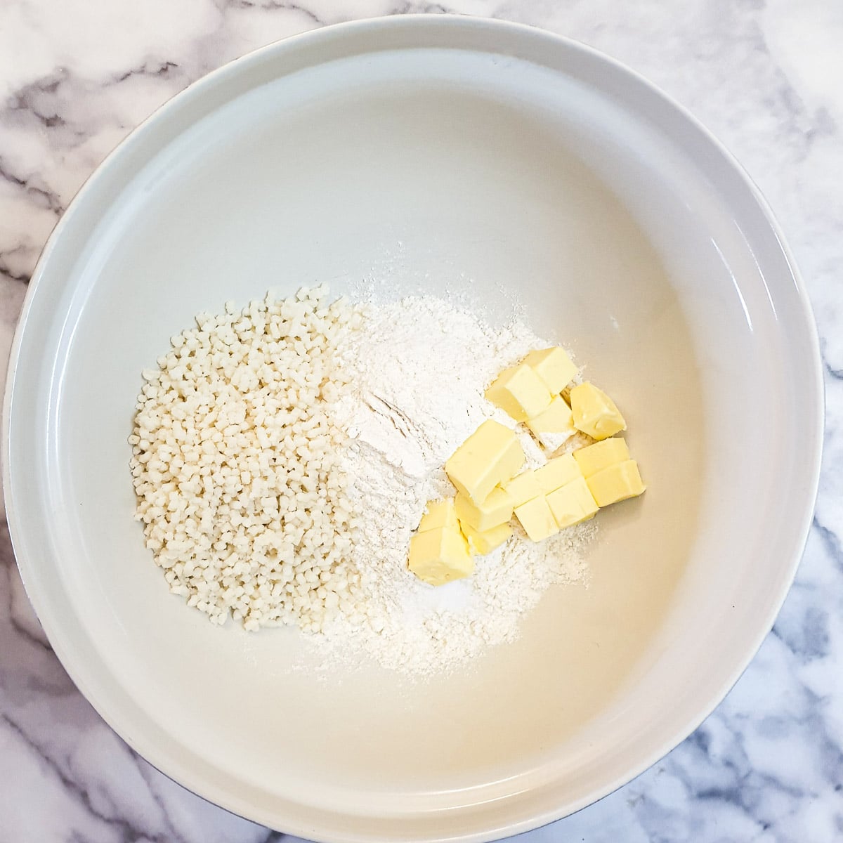 Flour, cubed butter and suet in a mixing bowl.