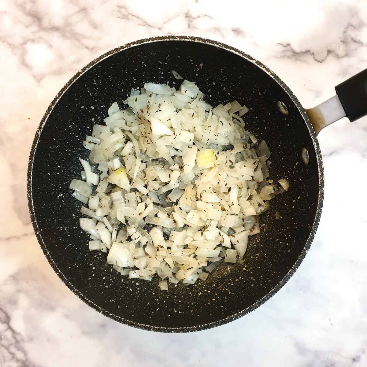 Chopped onions in a frying pan.