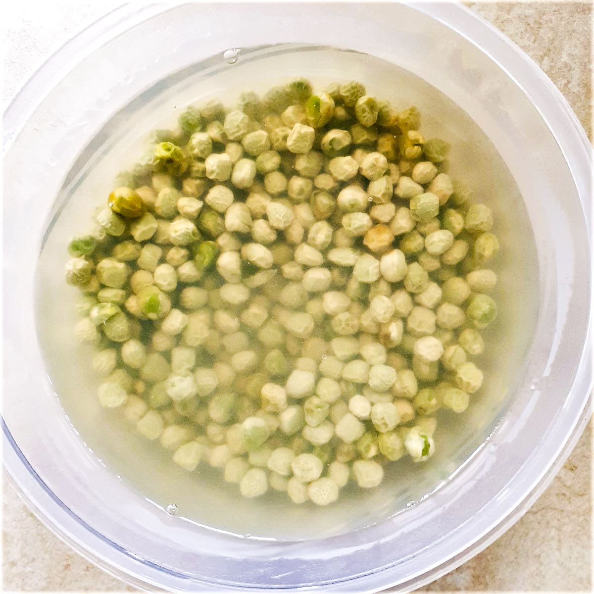Marrowfat peas soaking in a bowl of water.