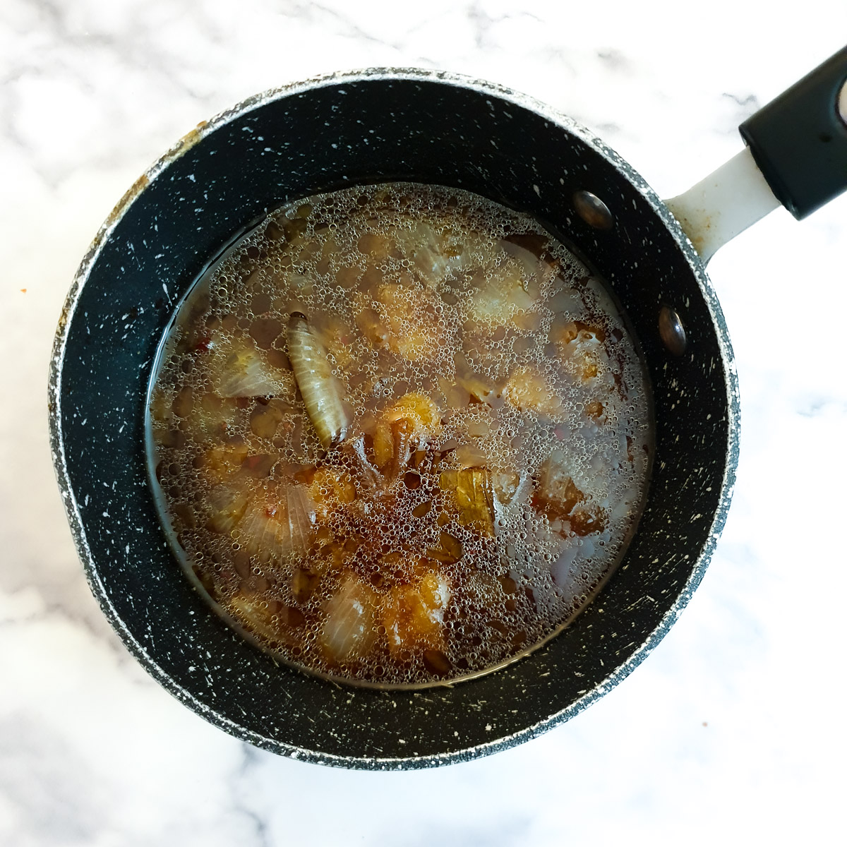 Cooking juices in a saucepan.