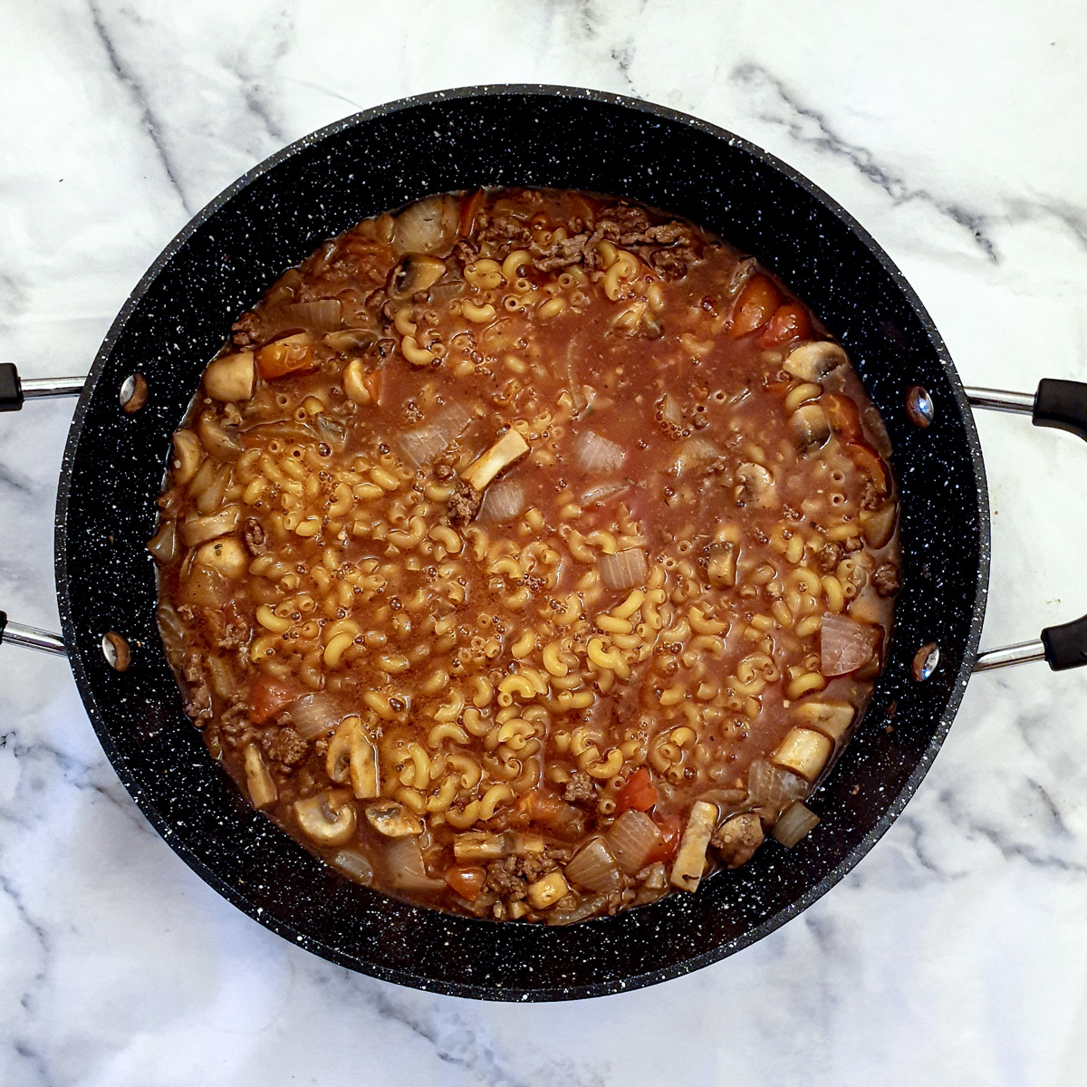 Stock and macaroni added to the goulash.