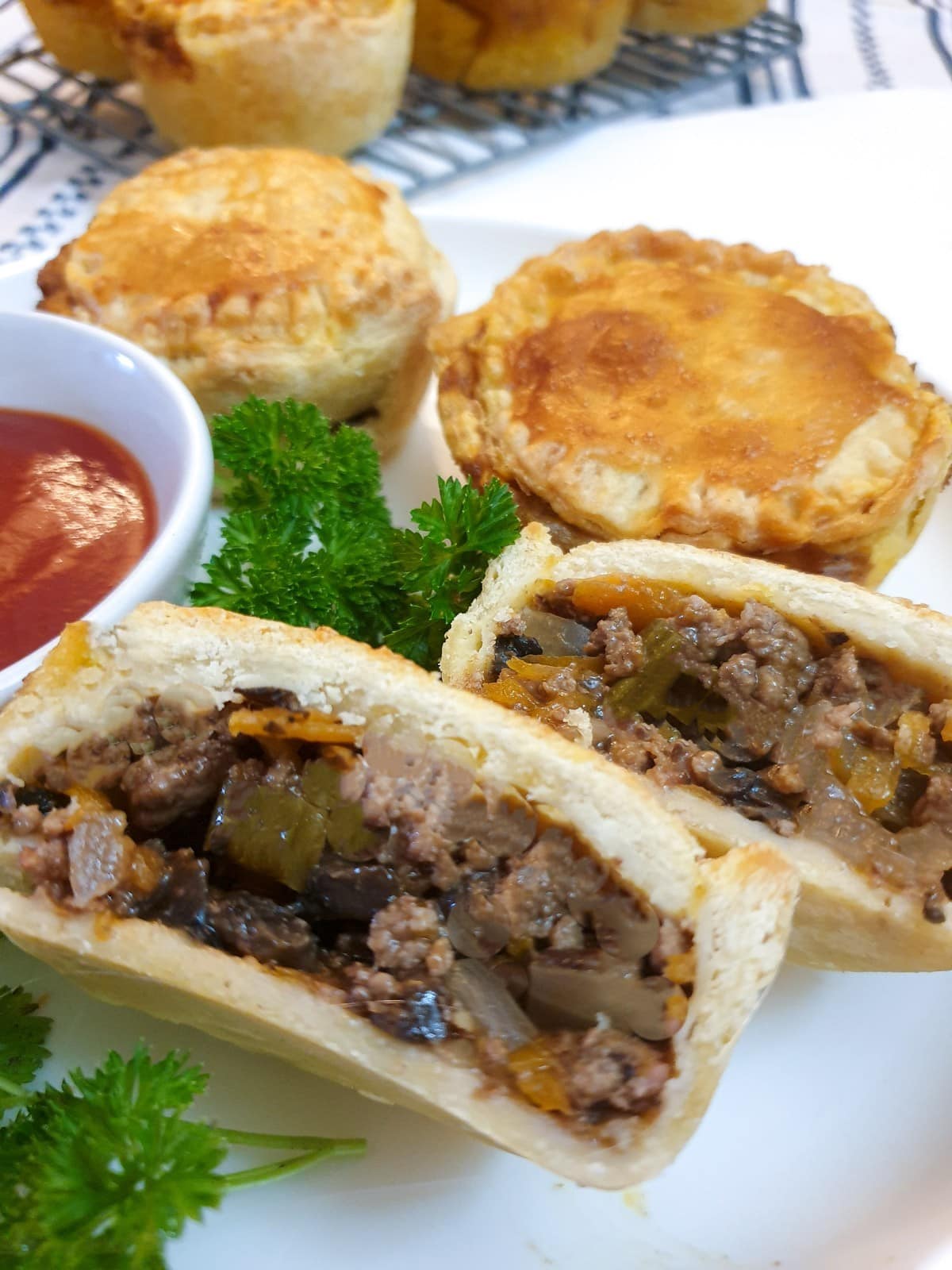 Close up of a beef, onion and mushroom pie cut in half.