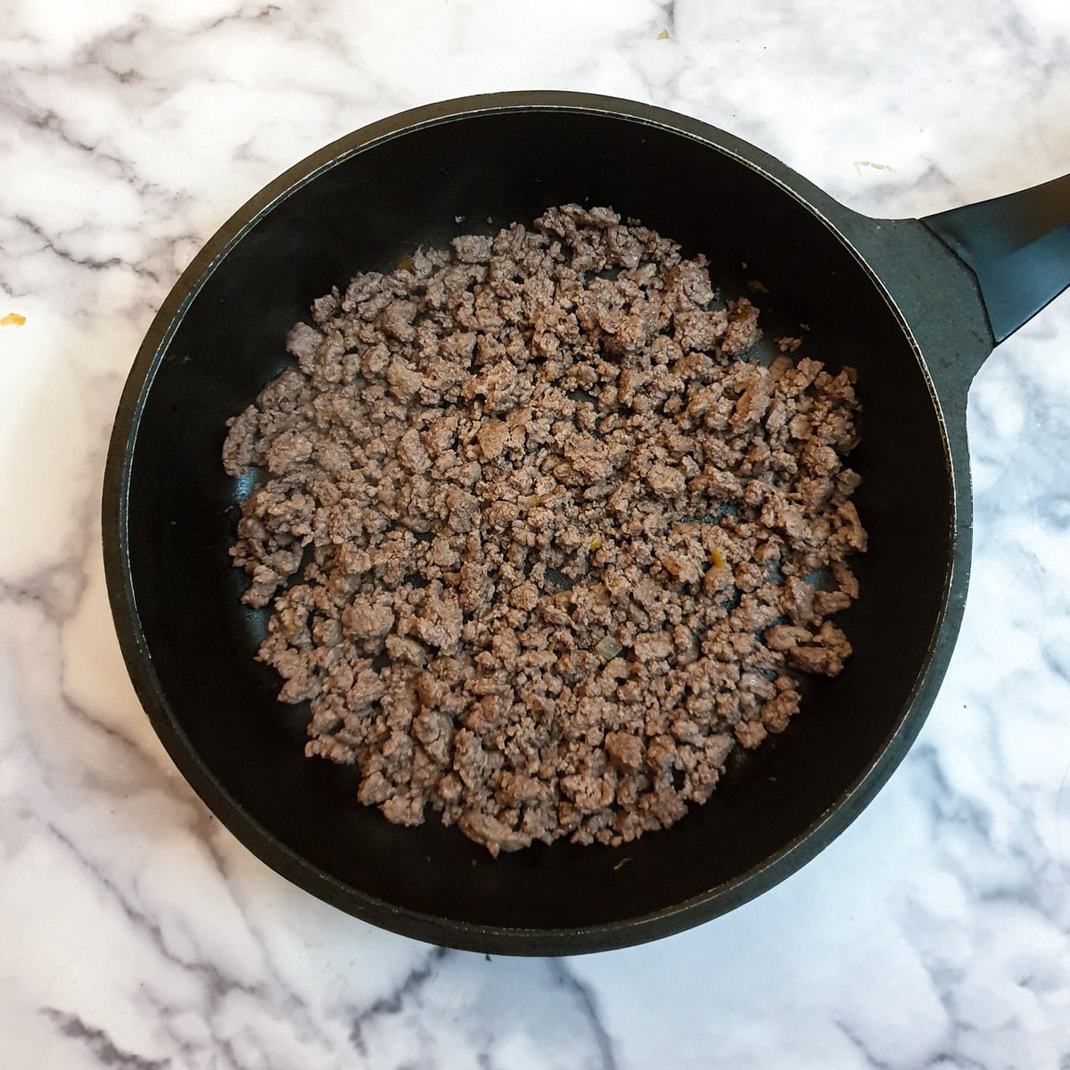 Minced beef browning in a frying pan,