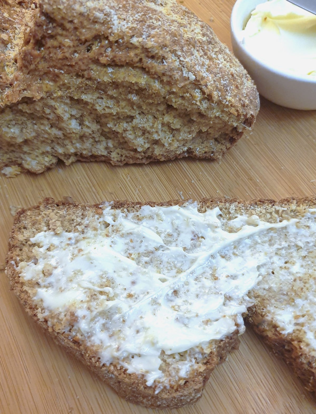 A slice of soda bread spread with butter.