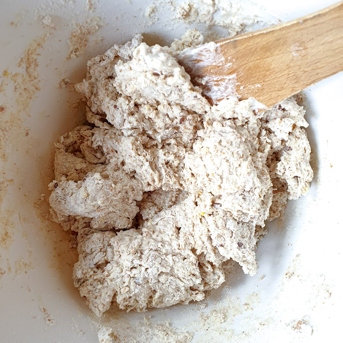 Soda bread dough being mixed with a spatula.