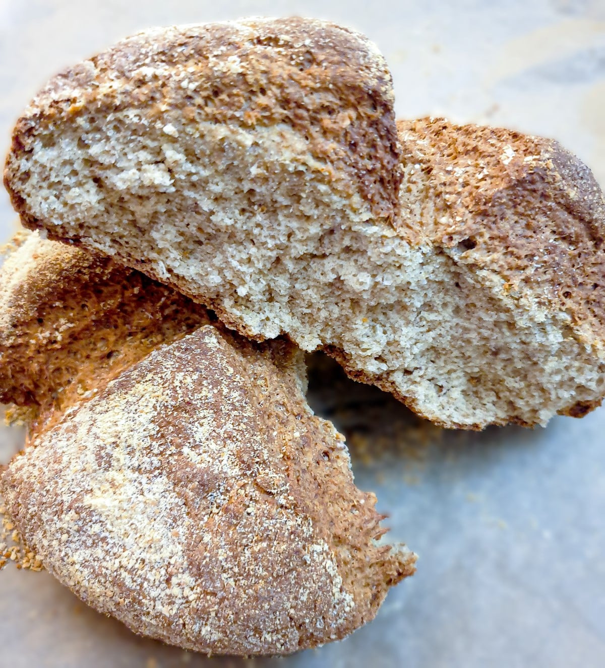 A baked loaf of cheese wholemeal soda bread cut in half to show the inside.