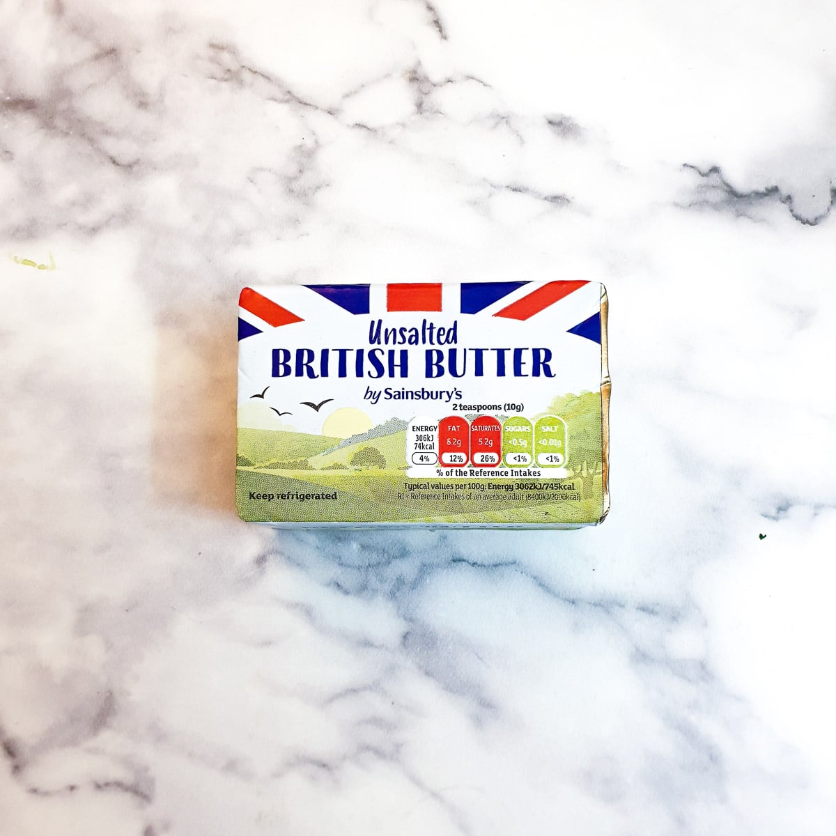 A wrapped block of butter on a work surface.