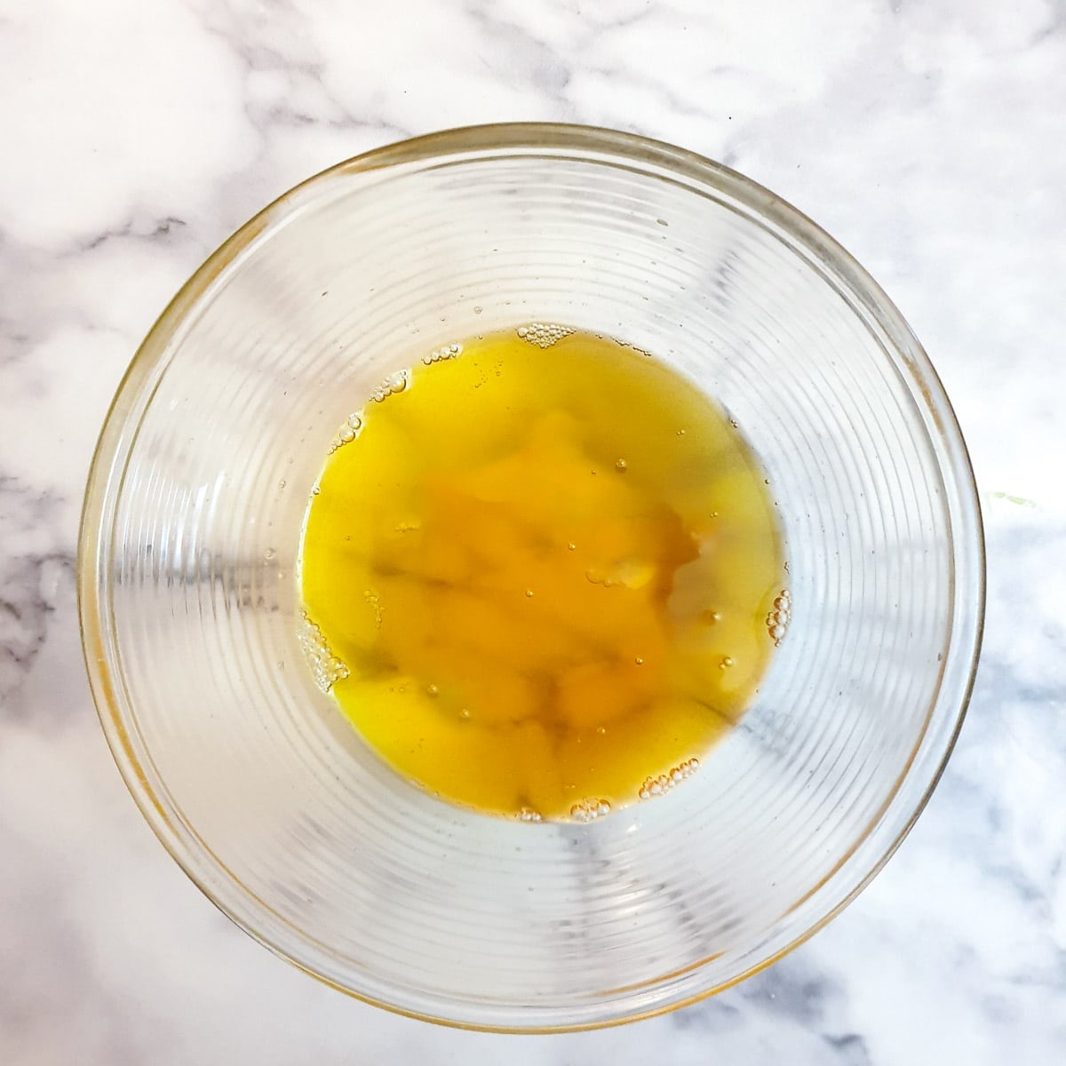 A glass bowl of liquid ghee.