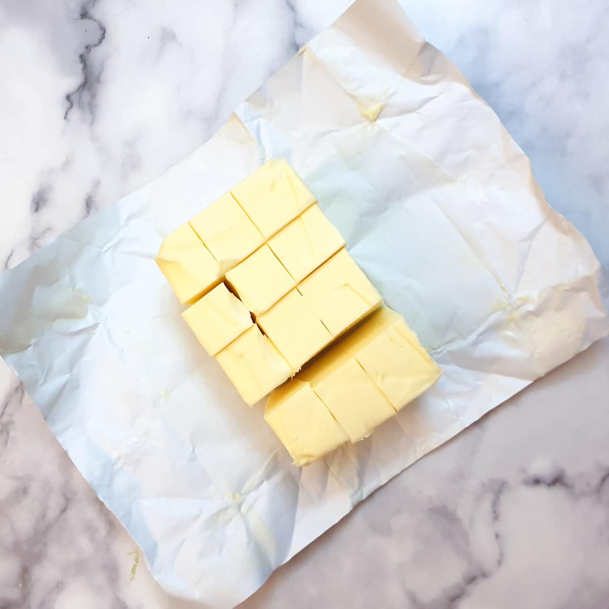 A block of butter cut into cubes.